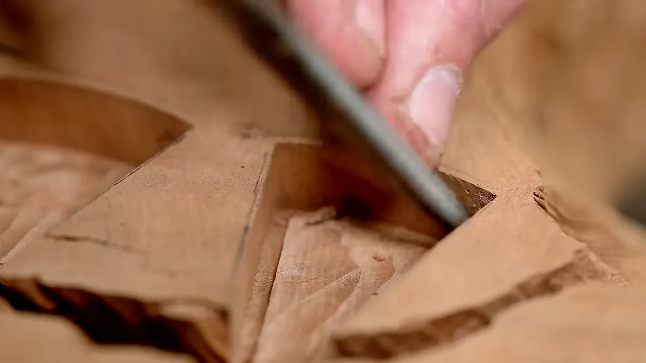 Chisel trimming the corner of a bow tie recess in the redwood slab