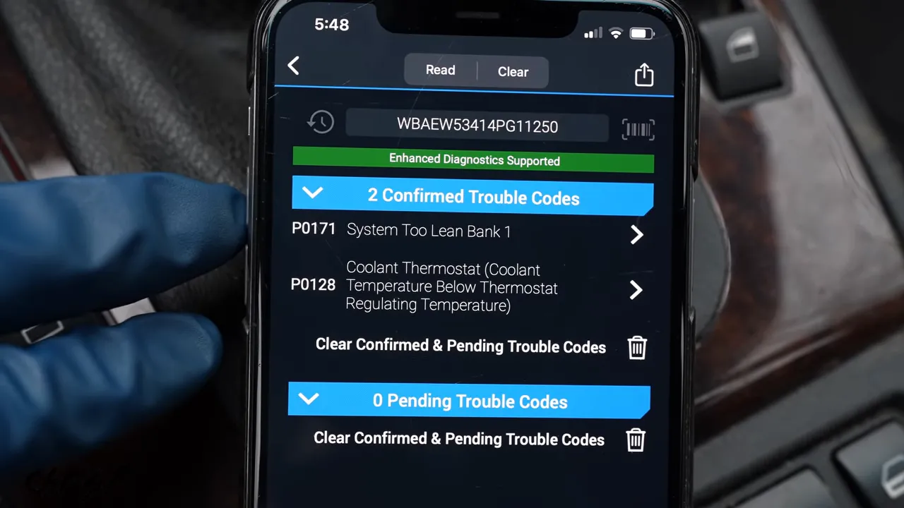 Phone screen displaying confirmed P0171 and P0128 diagnostic trouble codes