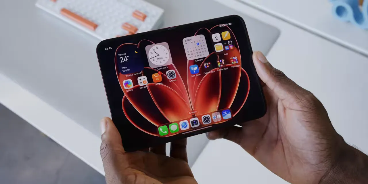 Xiaomi folding phone held open with widgets and app icons on its inner display
