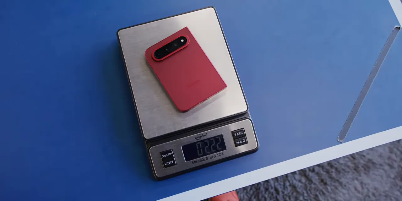 Red Xiaomi folding phone resting on a digital scale