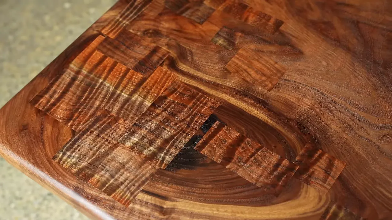 Finished walnut desk edge with a figured patch extending across the top and down the side