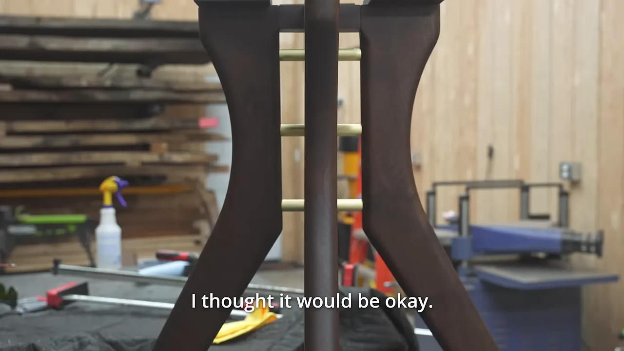 Assembled curved walnut table base with horizontal brass rods