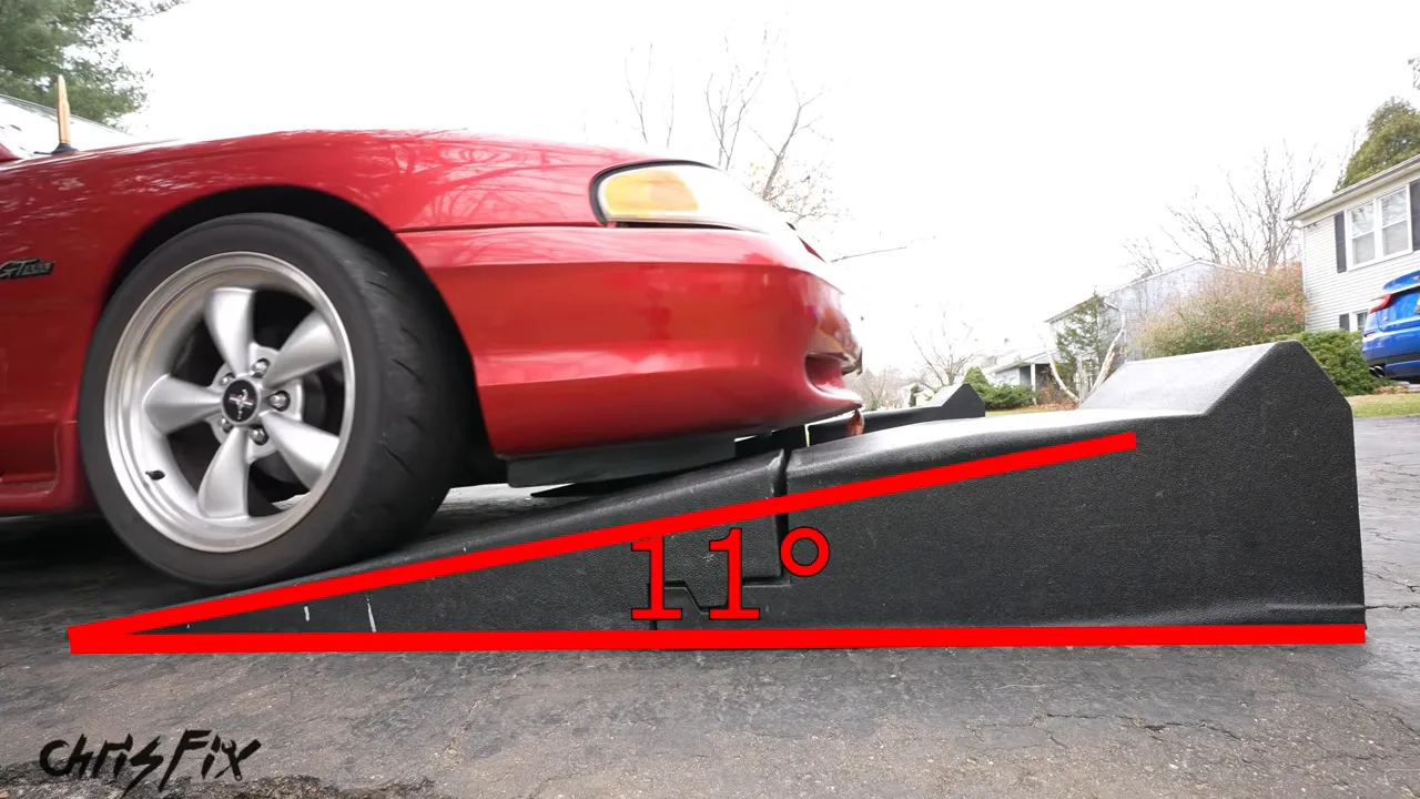 Red Mustang climbing a long ramp with an 11-degree approach-angle graphic