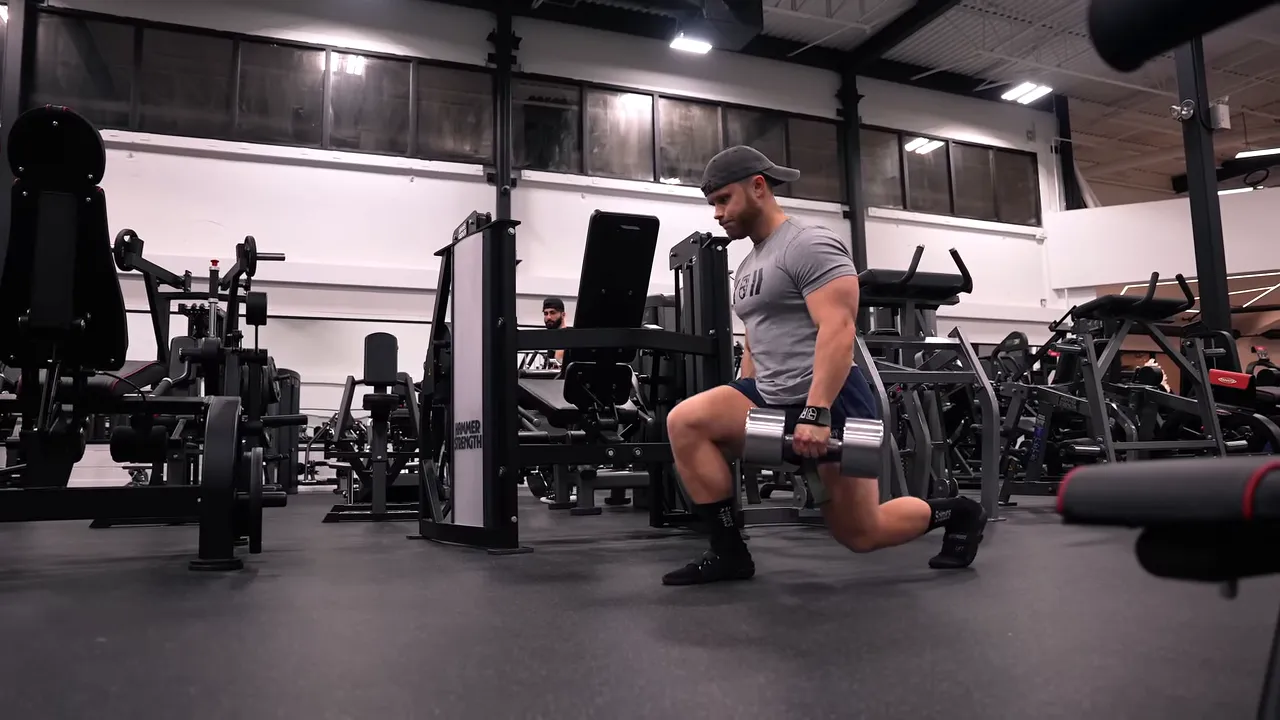 Side view of a dumbbell walking lunge with the rear knee near the floor