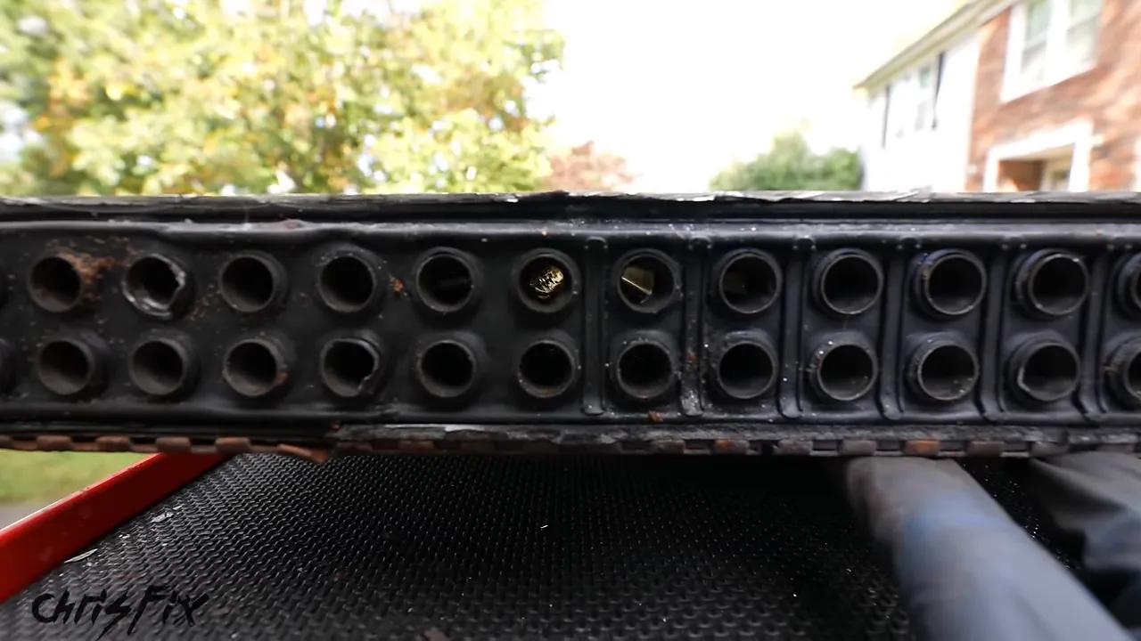 Open end of a radiator showing two rows of exposed tube openings