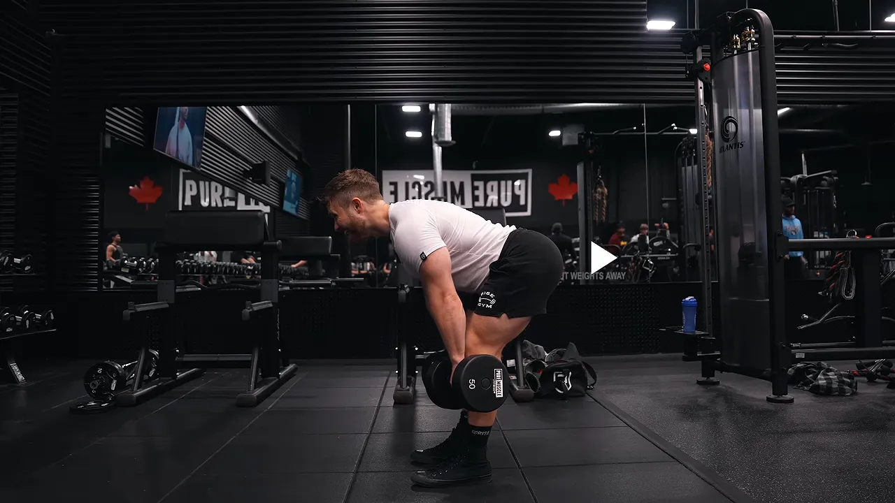 Side view of a dumbbell Romanian deadlift with the hips pushed backward and dumbbells below the knees