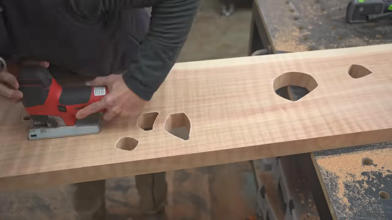 Jigsaw cutting organic openings into a long redwood board