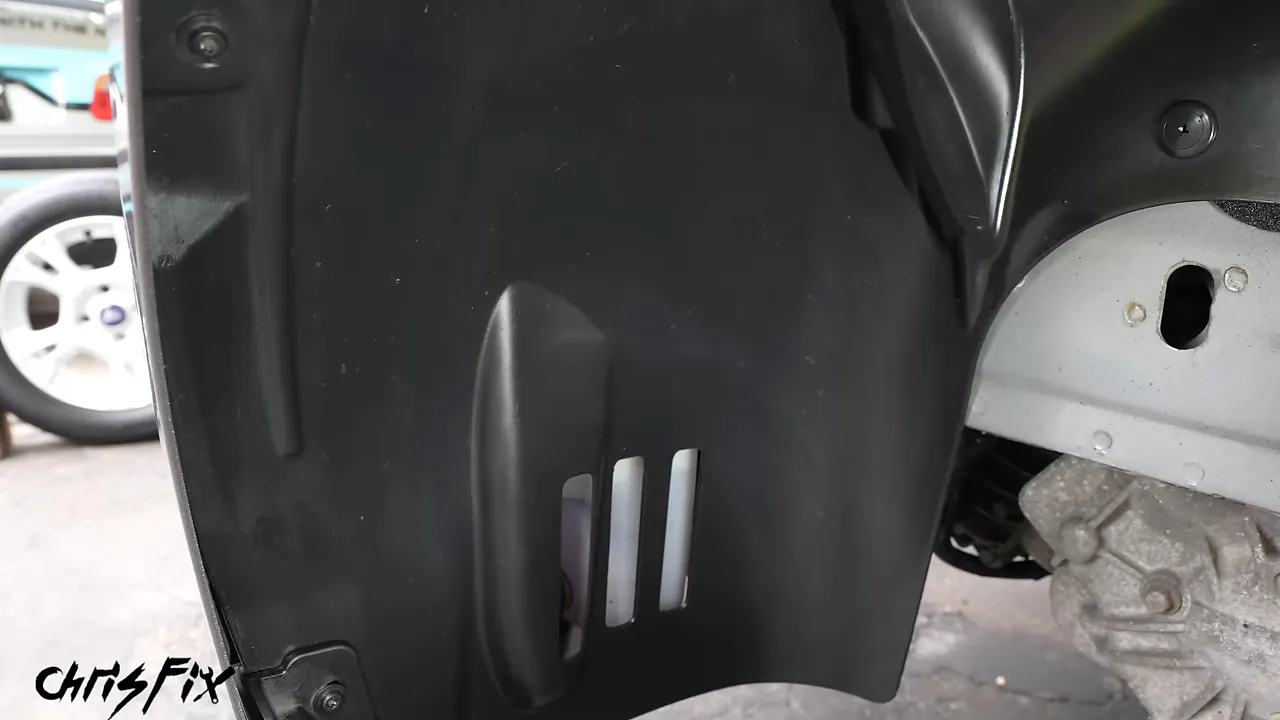 Black wheel well liner with visible water droplets on its surface