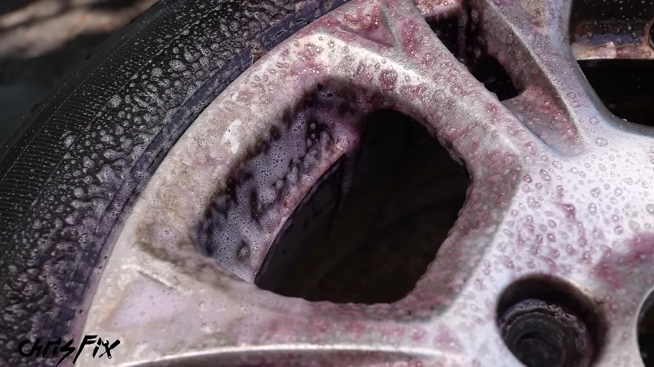 Purple wheel cleaner covering the silver spokes and rim edge