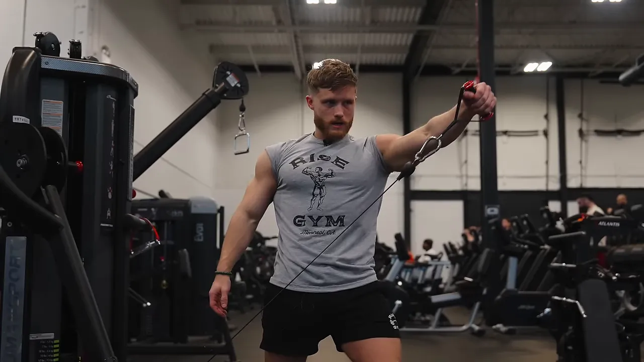 Jeff performing a single-arm cable Y-raise with his working arm raised diagonally