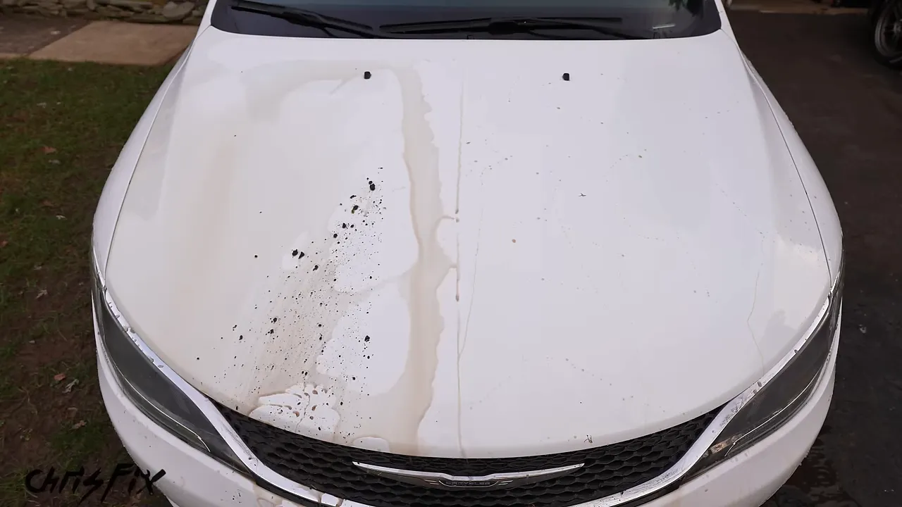 White hood divided by yellow tape with dirt remaining mainly on the left half