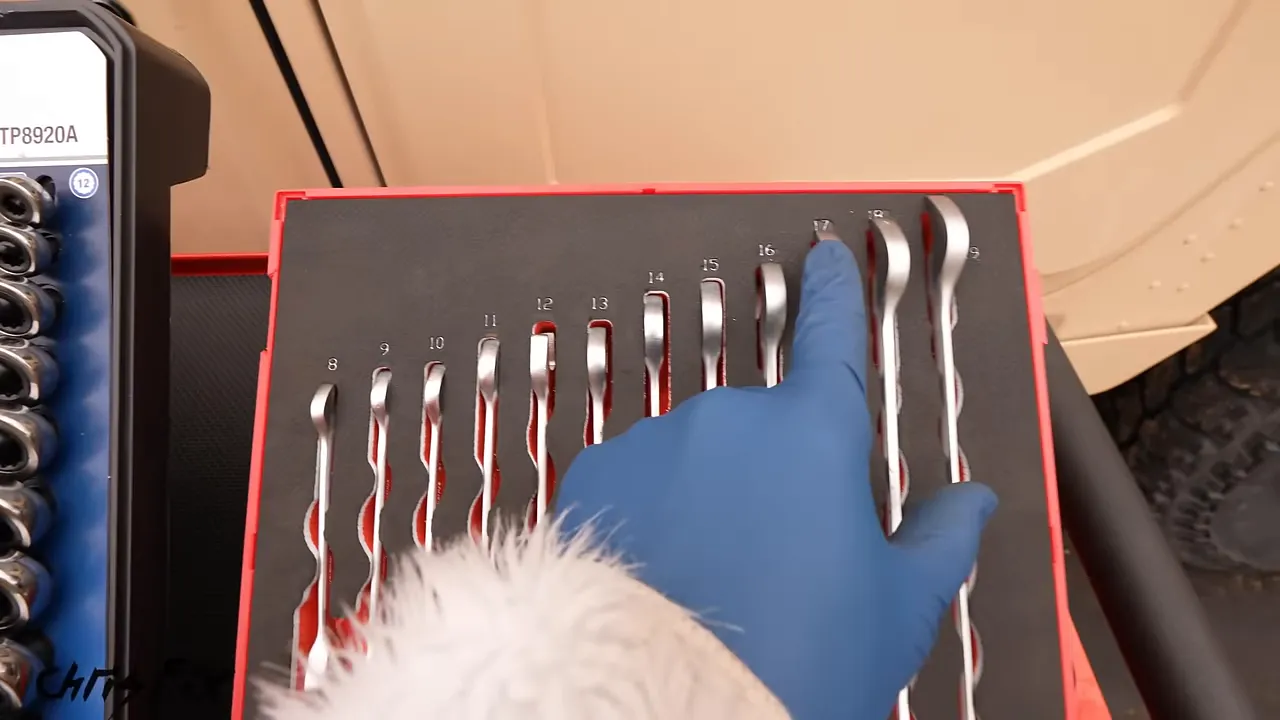 Metric ratcheting wrenches arranged in individual cutouts in a black and red foam tray