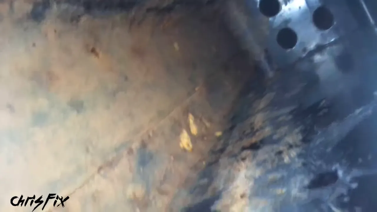 Borescope view inside a vehicle frame rail with surface rust along the lower metal