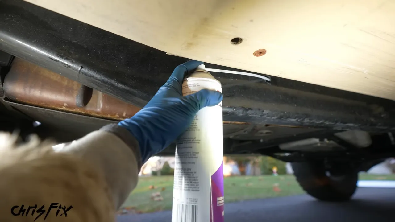Cavity wax can connected to a long wand inserted into a vehicle frame rail