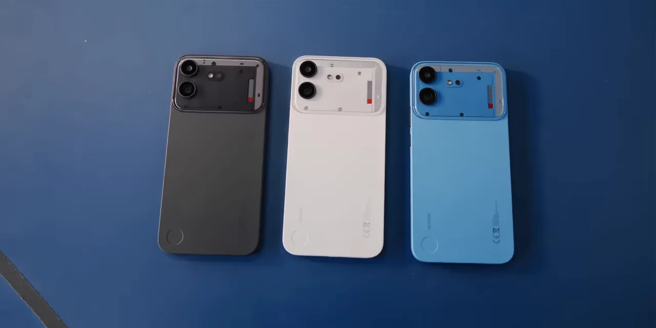 Black, white, and blue Nothing Phone 4b phones arranged on a blue surface