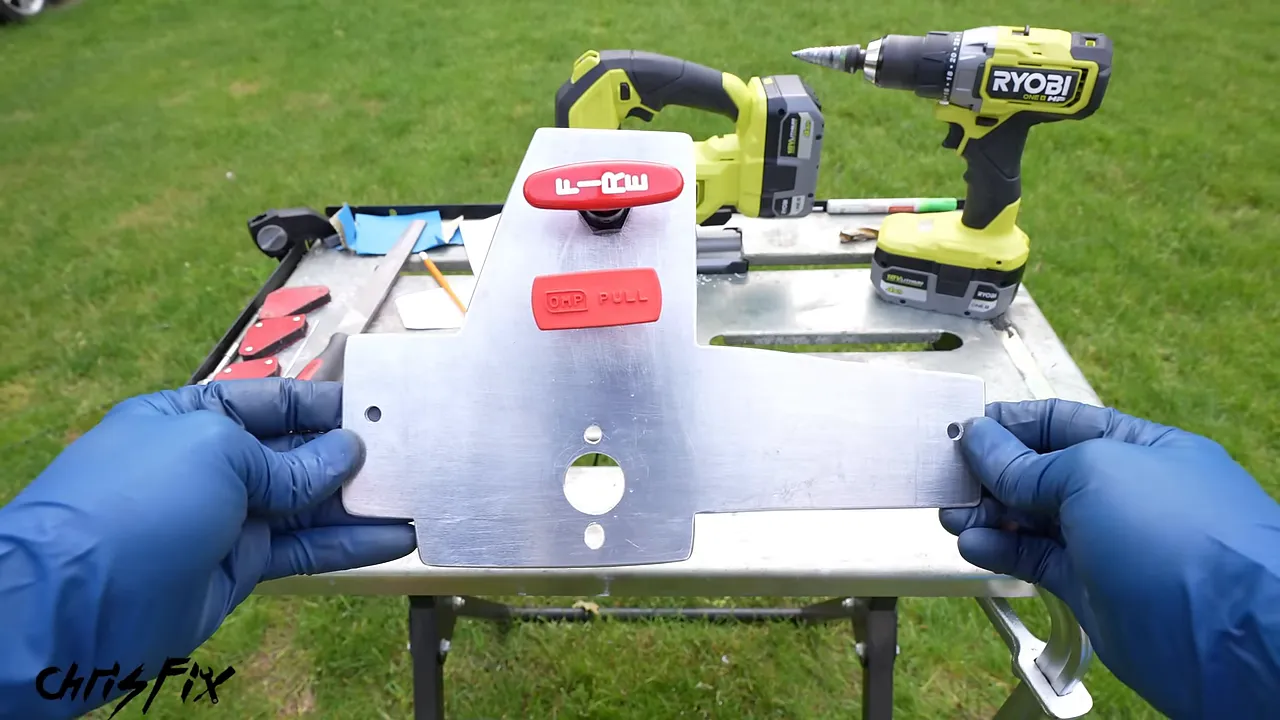 Aluminum mounting panel with a red battery switch and two red pull handles fitted