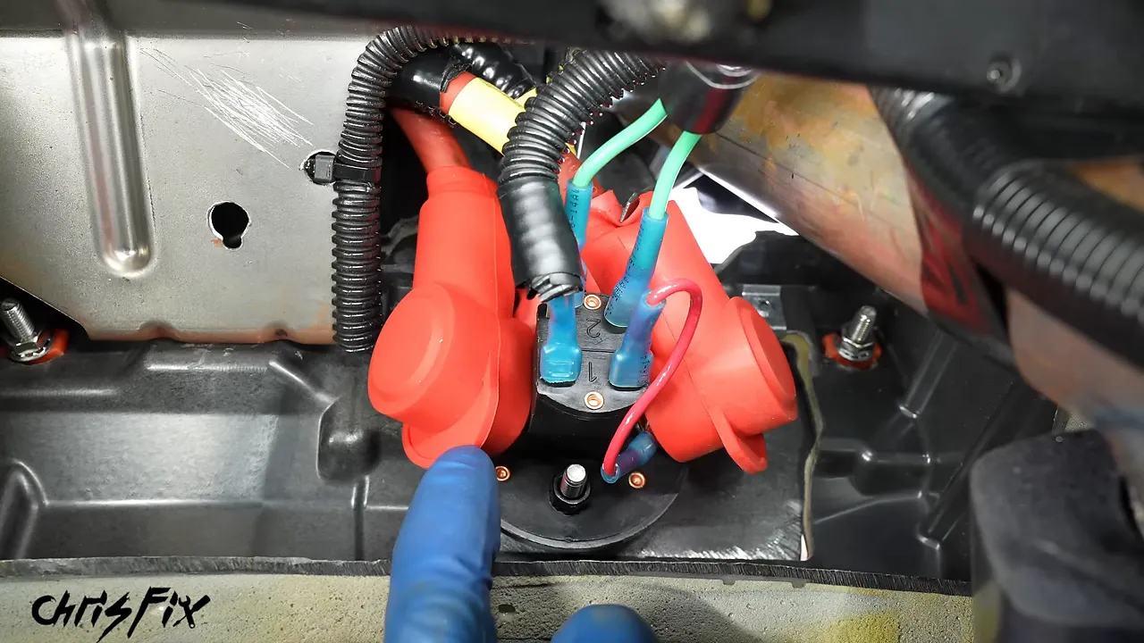 Rear of the mounted kill switch with red insulating covers over the two large cable studs