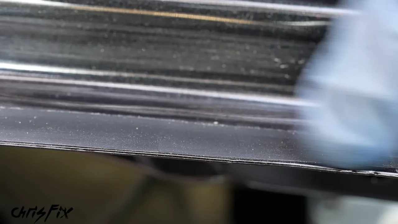 Close-up of a thin trimmed urethane layer on the rear window pinch weld