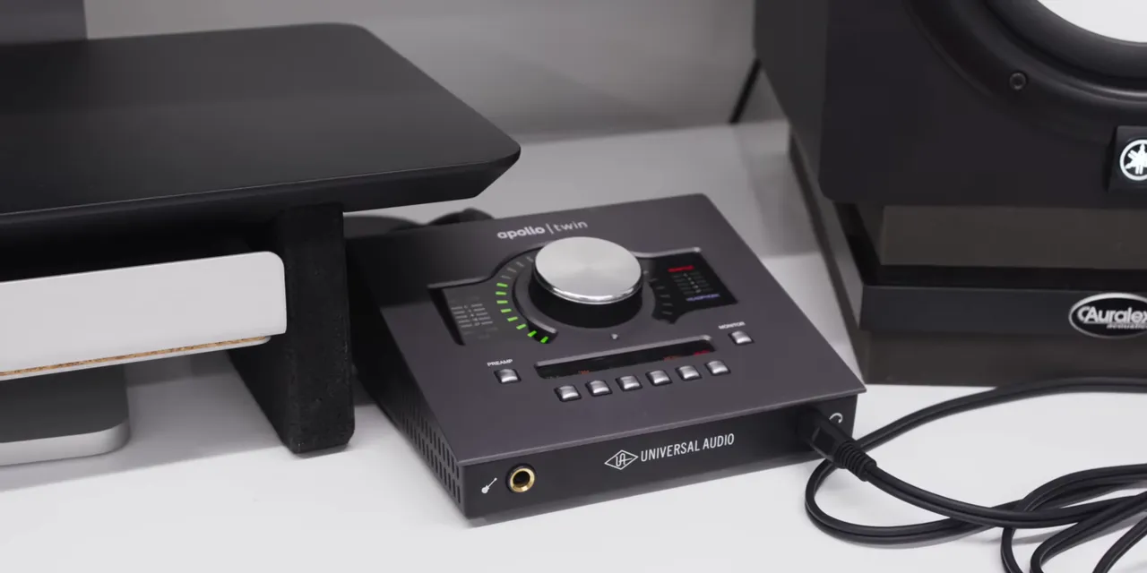 Apollo Twin audio interface with a large silver dial and illuminated level indicators