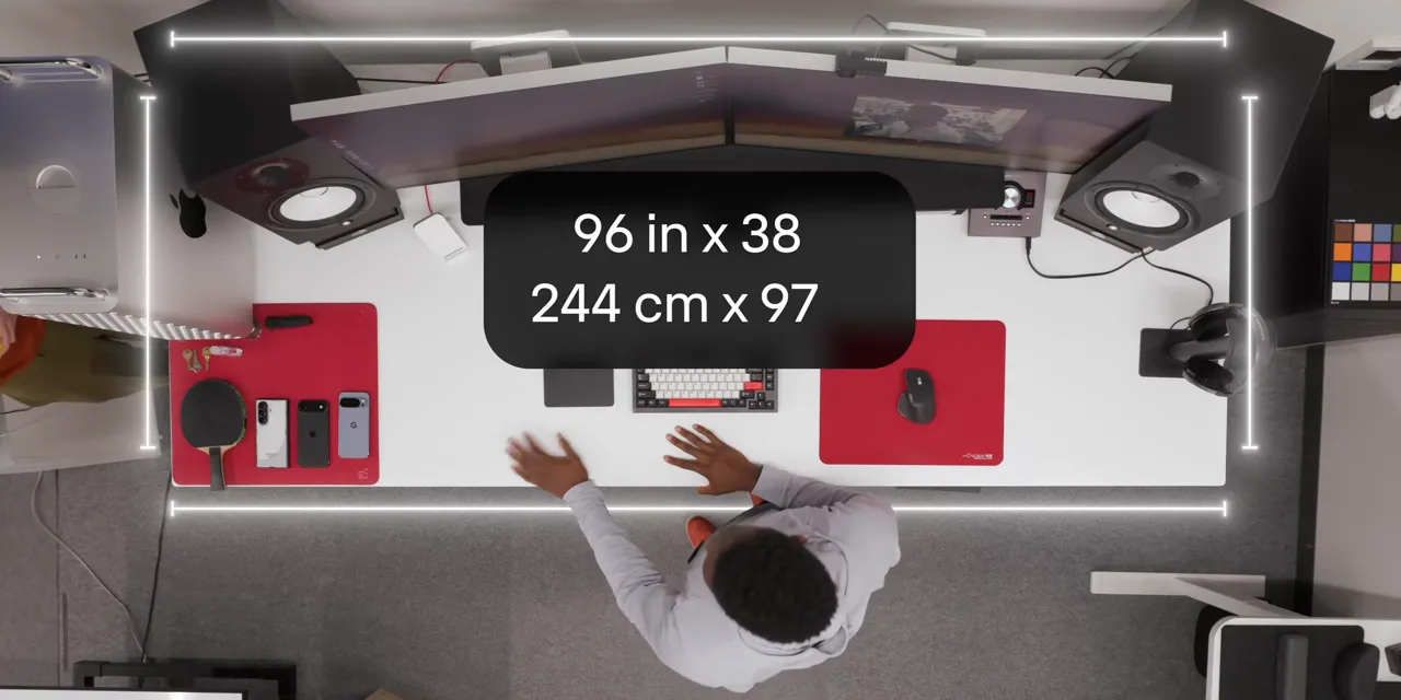 Overhead desk view with dimensions labeled 96 by 38 inches and 244 by 97 centimeters