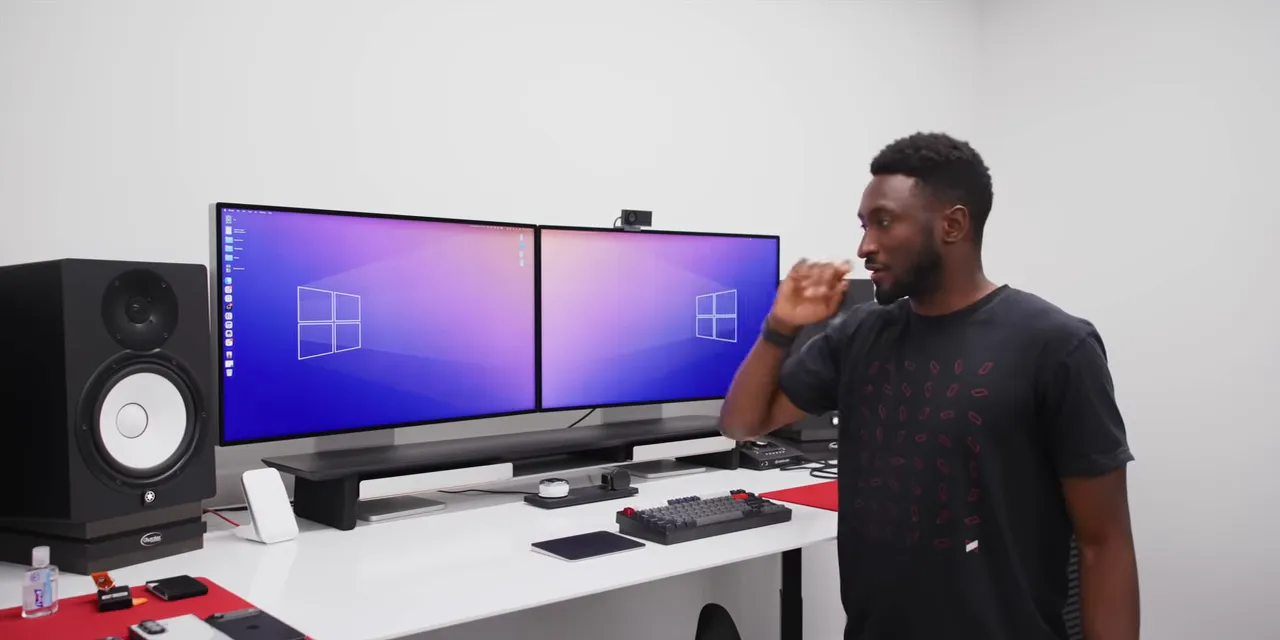 Two adjacent displays on silver stands with a webcam above the right display