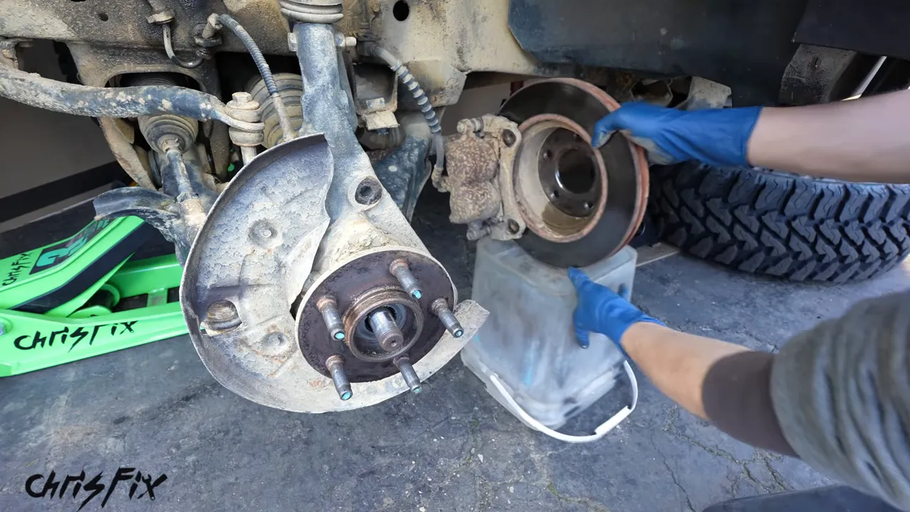 Brake rotor and caliper supported beside the exposed wheel hub