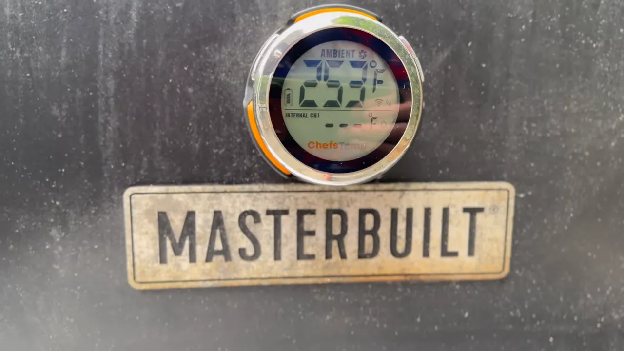 ChefsTemp digital gauge mounted above the Masterbuilt badge displaying approximately 253 degrees Fahrenheit