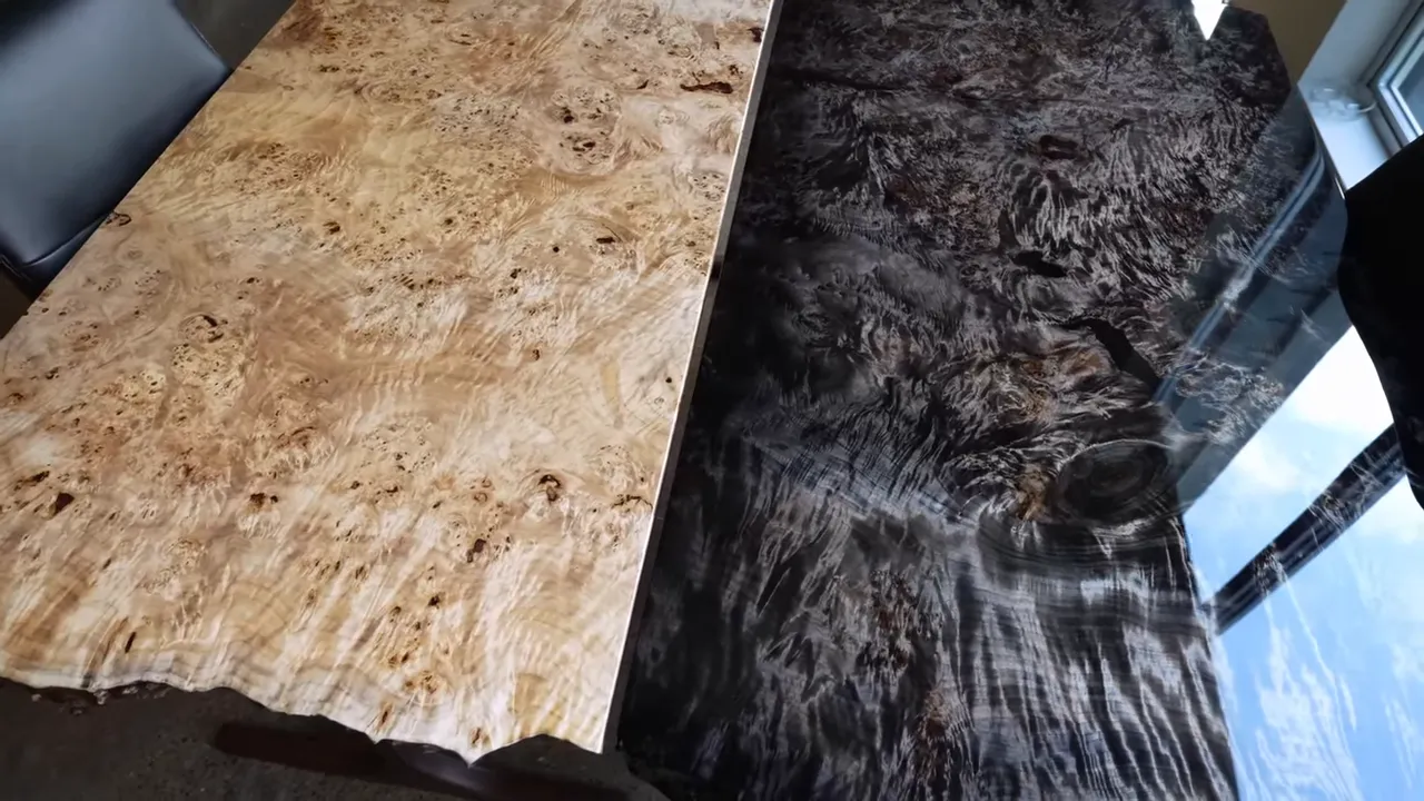 Light natural burl desktop beside a dark glossy burl desktop