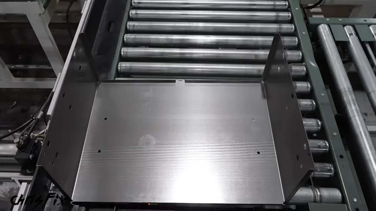 Formed steel drawer body with two upright sides on a roller conveyor