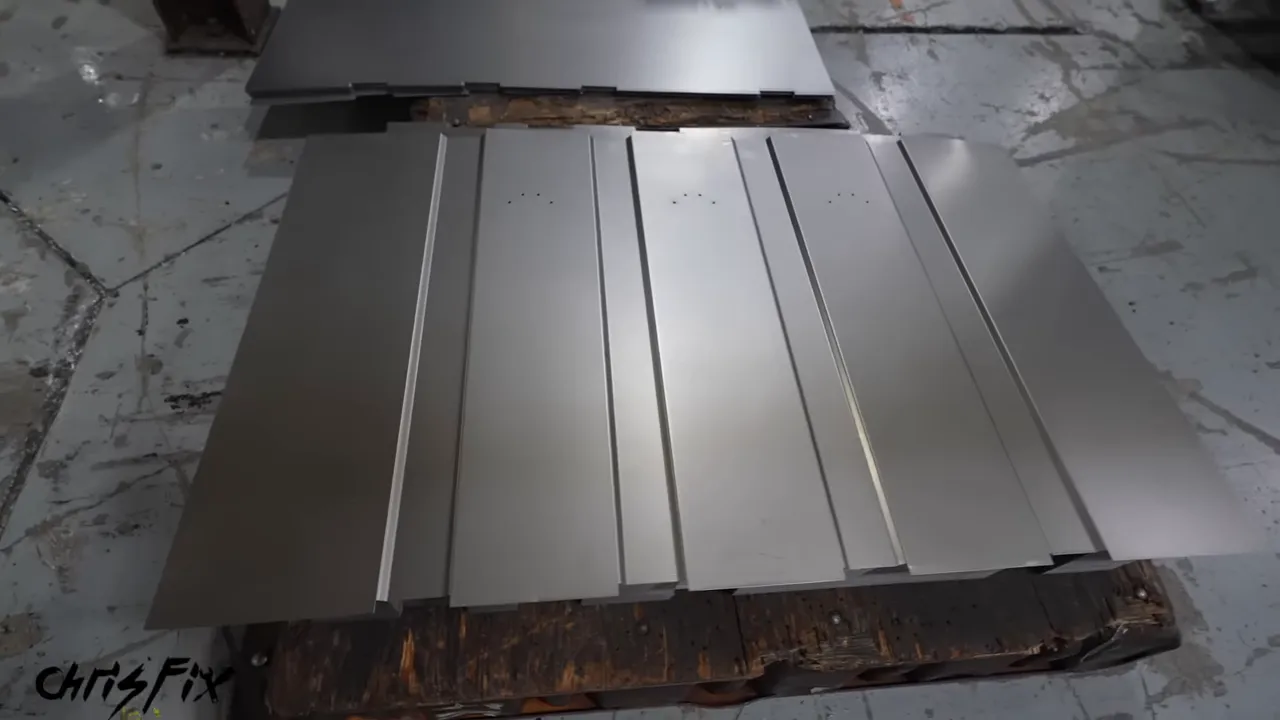 Steel back panel with four long reinforcing ridges beside a flat panel
