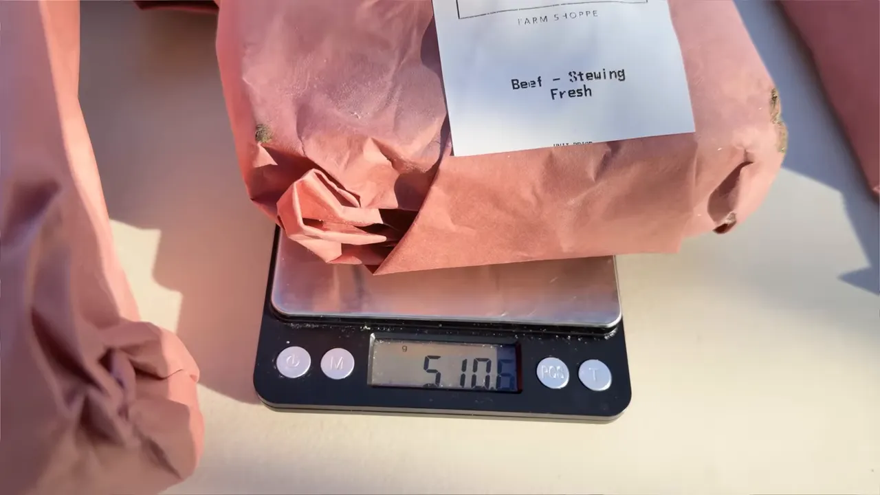 A paper-wrapped beef package resting on a digital kitchen scale