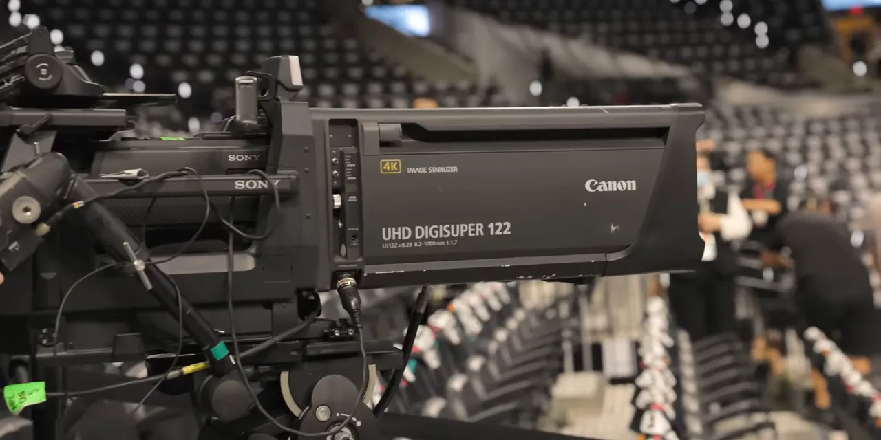Side view of a Canon UHD DIGISUPER 122 box lens mounted on a broadcast camera