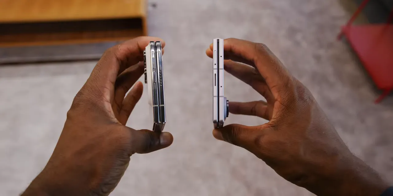 Two folded phones held side by side with their edge profiles visible