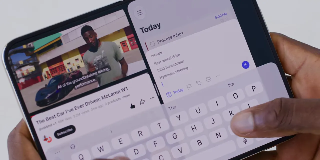YouTube and a notes app open side by side above the on-screen keyboard