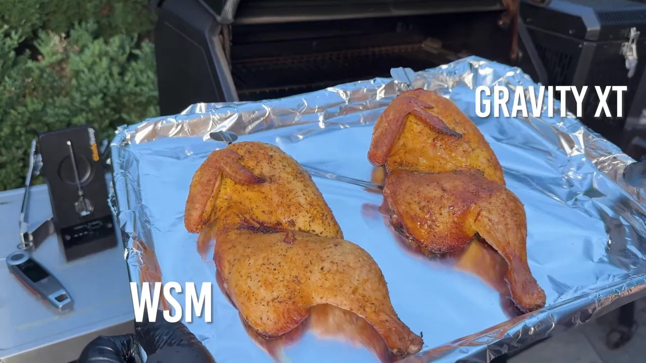 Two cooked chicken halves on a foil-lined tray labeled WSM and GRAVITY XT