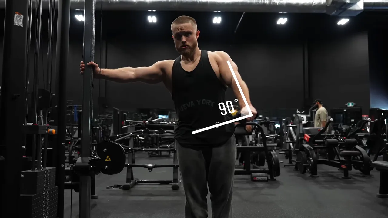 Cable lateral raise setup with a 90-degree angle marked between the cable and working arm