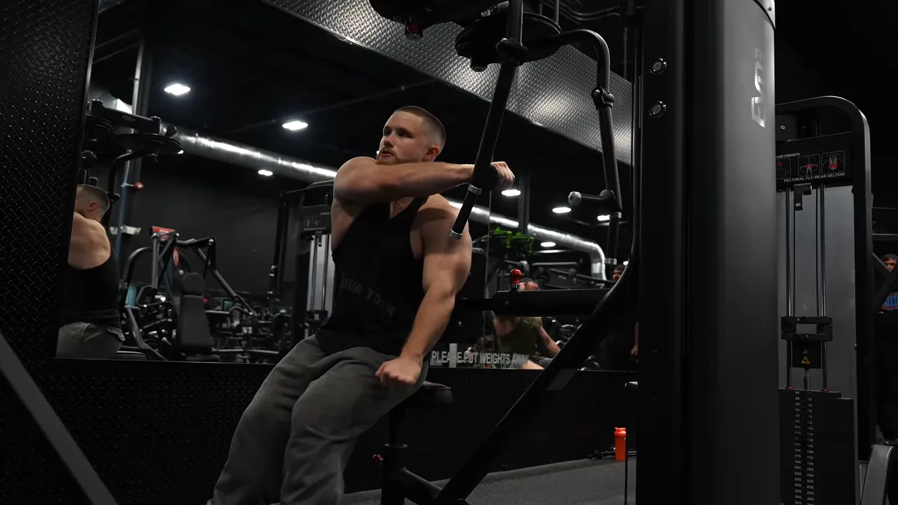 Sideways reverse pec deck setup with the working arm reaching across the chest