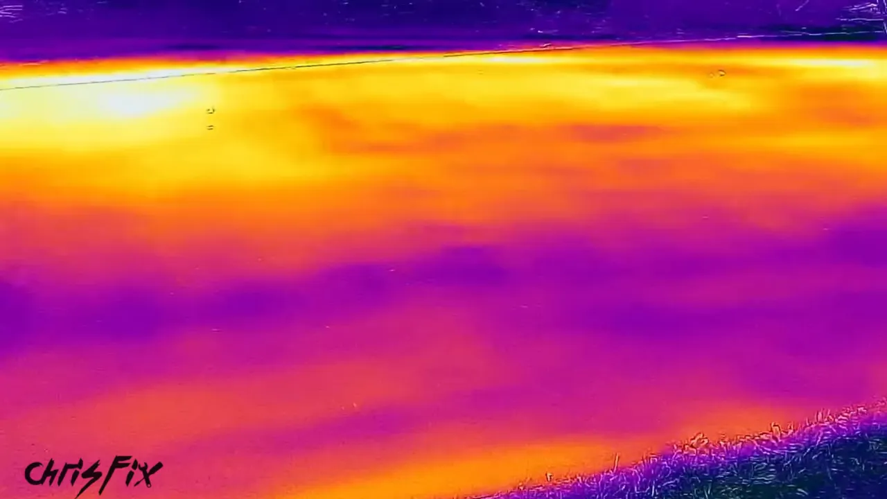 Thermal image showing yellow and orange areas across the driveway with purple areas in the foreground