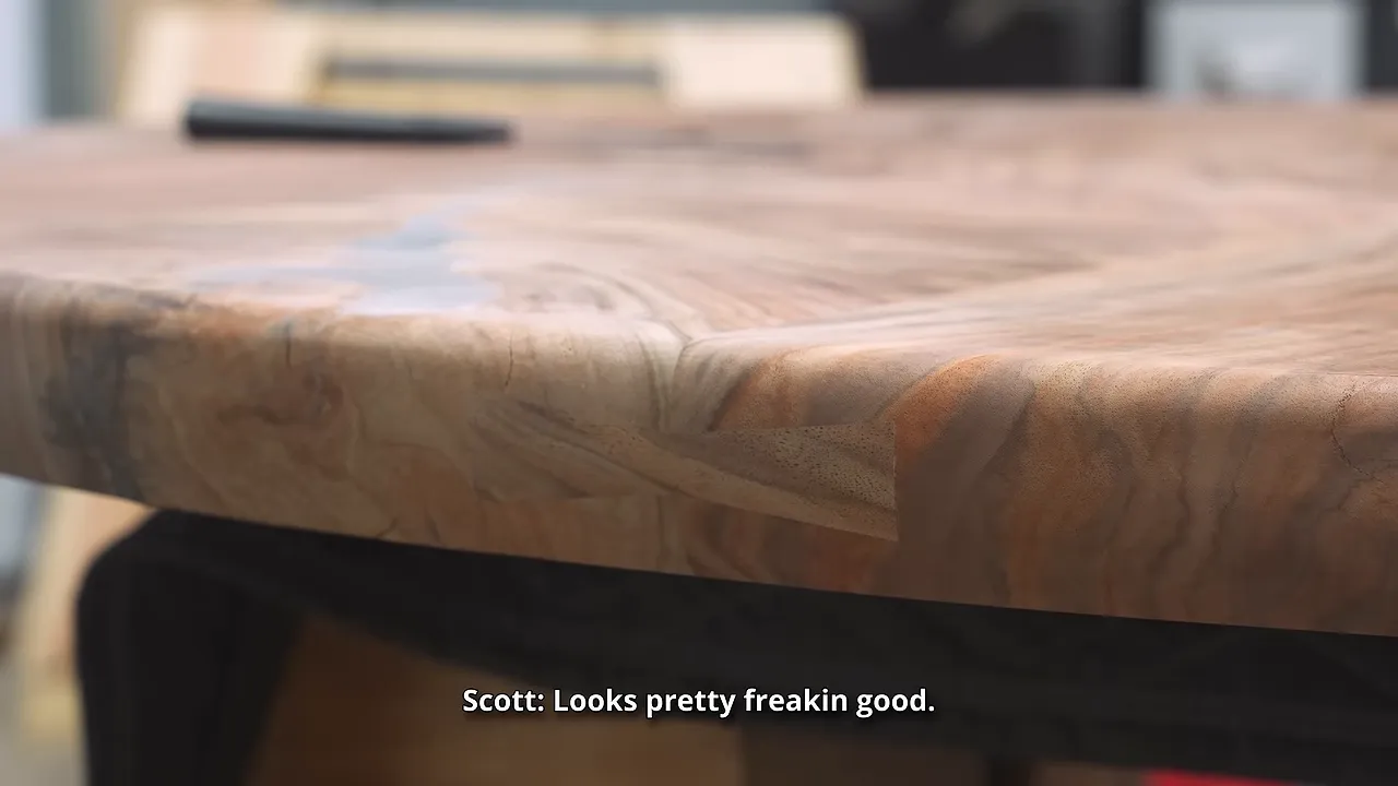 Bow tie inlay following the rounded edge of the walnut tabletop