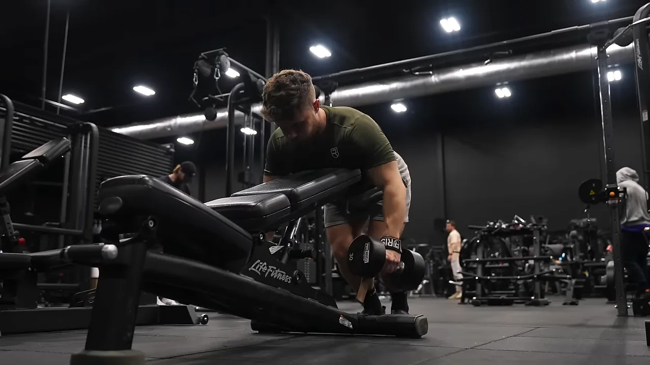 Dumbbell row performed with the chest braced against the raised backrest of an incline bench