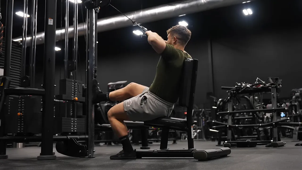 Seated rope face pull performed on a bench at a cable station