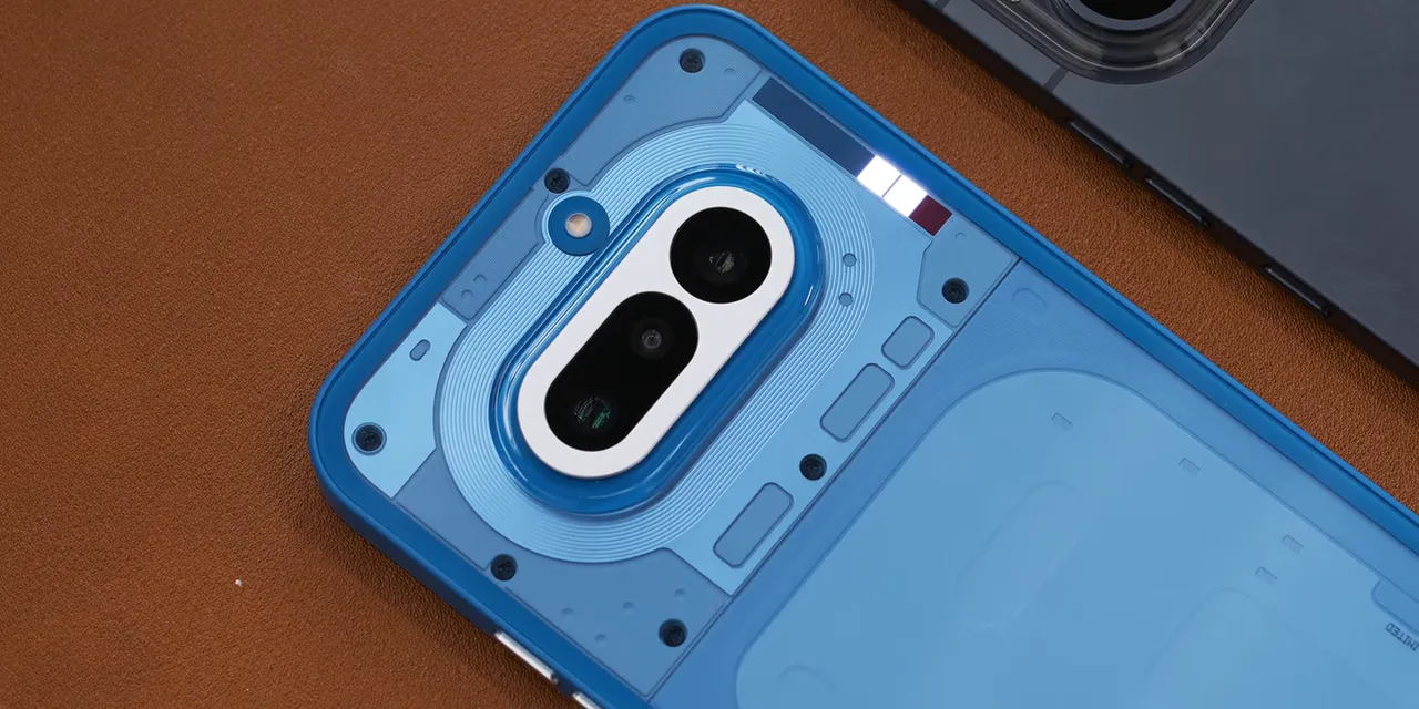 Blue Nothing Phone 4A lying face down with several lights illuminated in its rear Glyph Bar