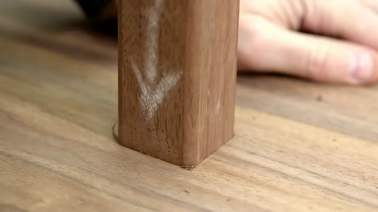 Rounded wooden tenon beside the matching mortise in the walnut stem