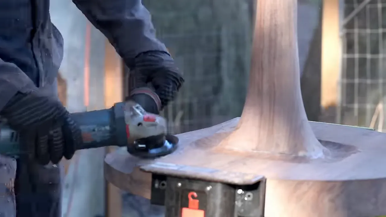 Carving disc shaping the curved transition between the walnut stem and round foot