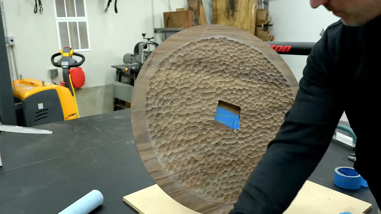 Textured underside of the round walnut foot with a smooth outer rim and central recess