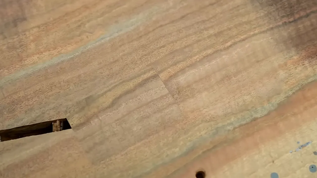 Sanded walnut surface showing the rectangular patch beside a narrow slot