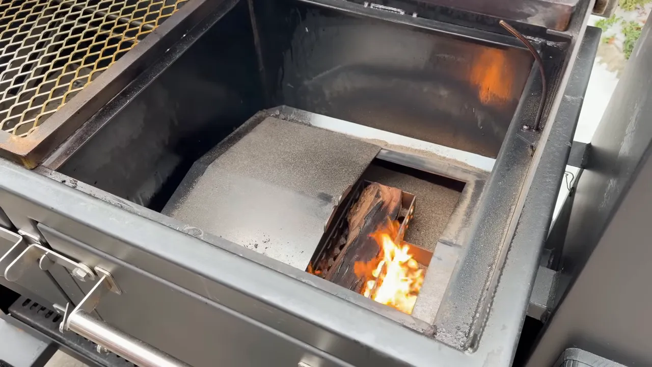 Wood burning in an exposed rectangular opening beneath the Lone Star Grillz cooking grate
