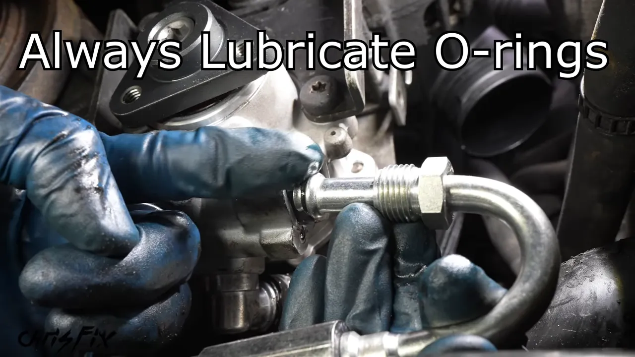 Gloved finger applying fluid to the O-ring at the end of the high-pressure steering line