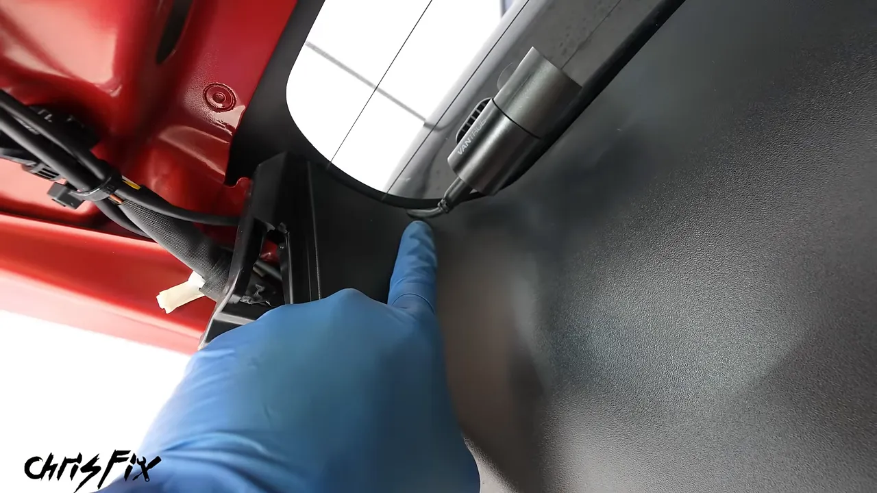 Rear camera cable exiting through a small notch in the reinstalled hatch trim