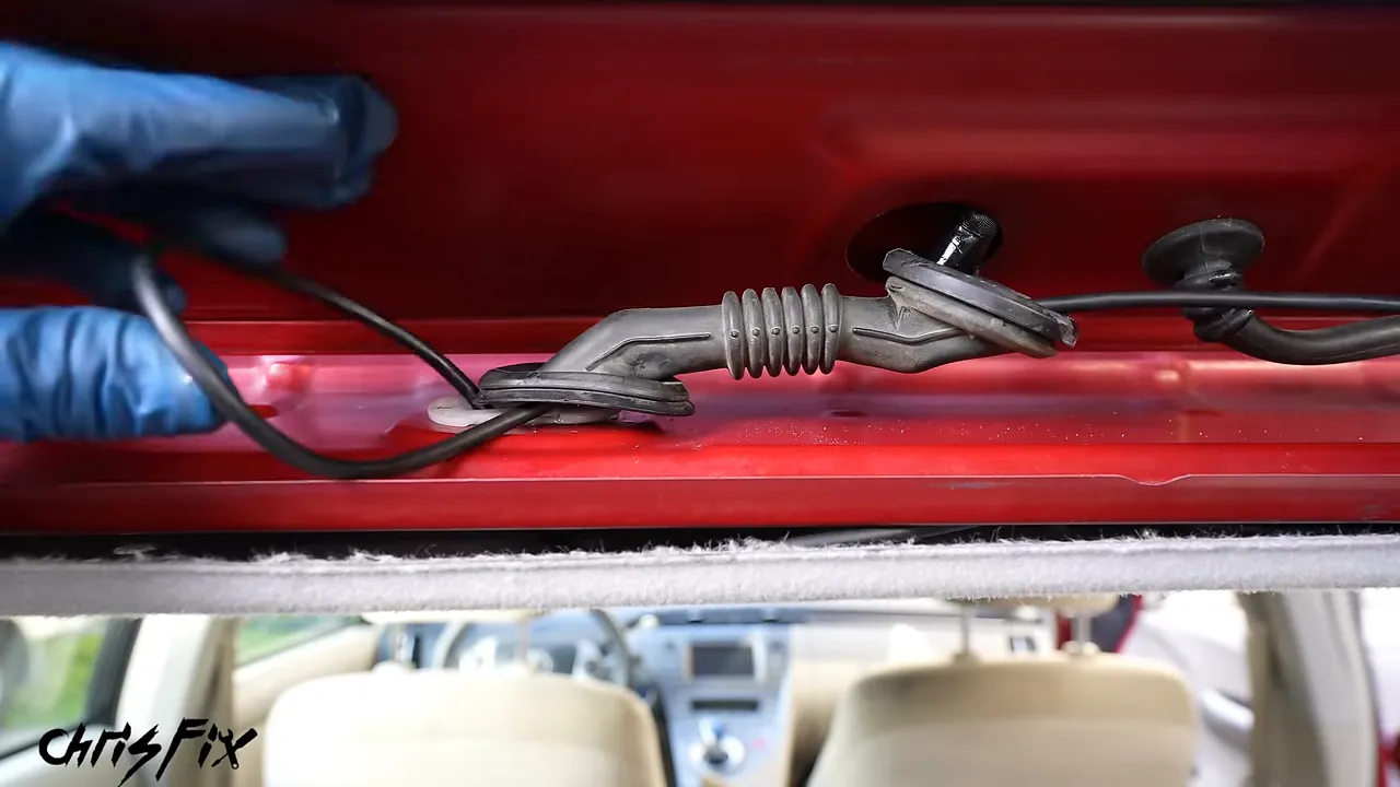 Camera cable running through the factory rubber wiring boot between the roof and open hatch